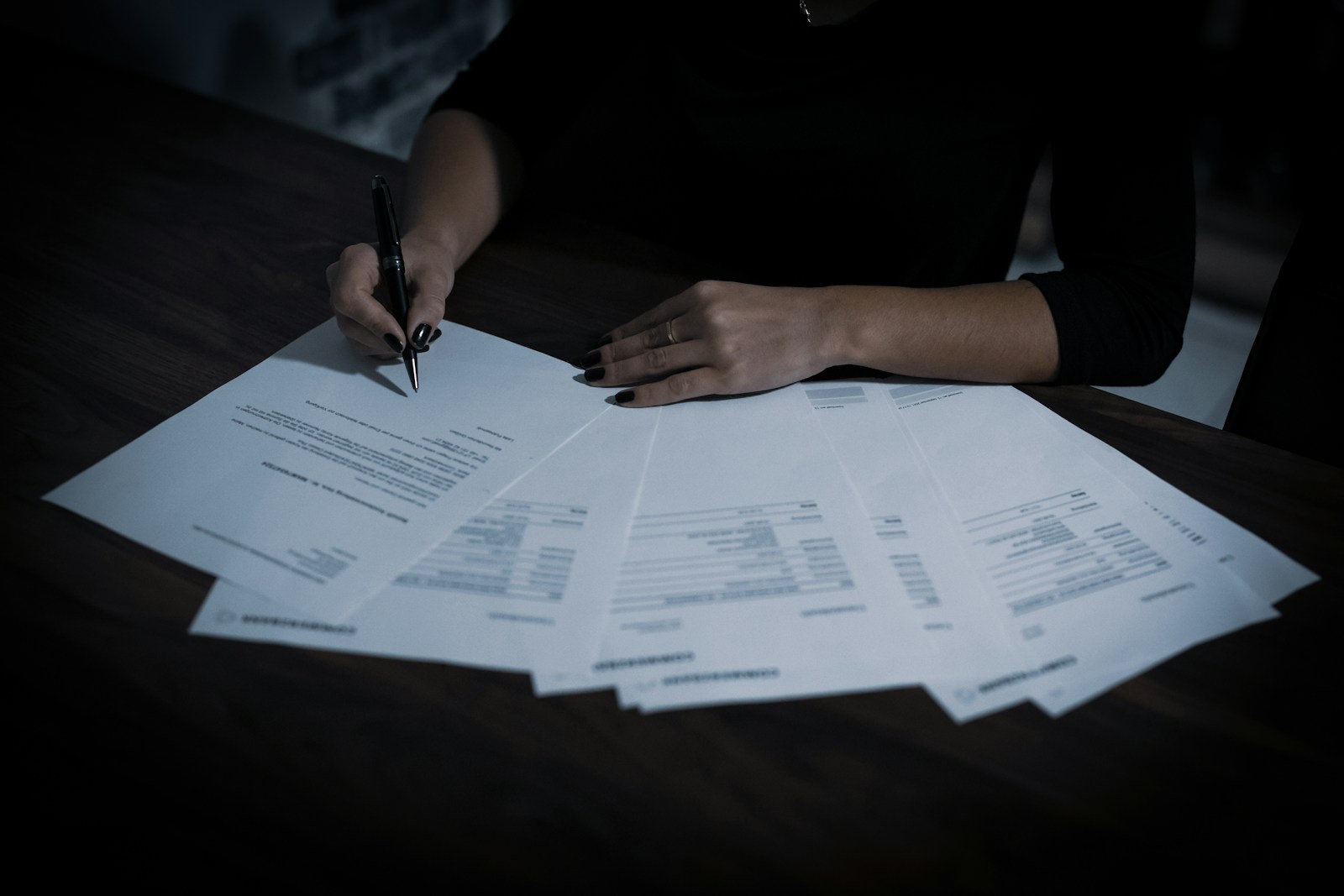 A contract being signed, representing legal and regulatory obligations